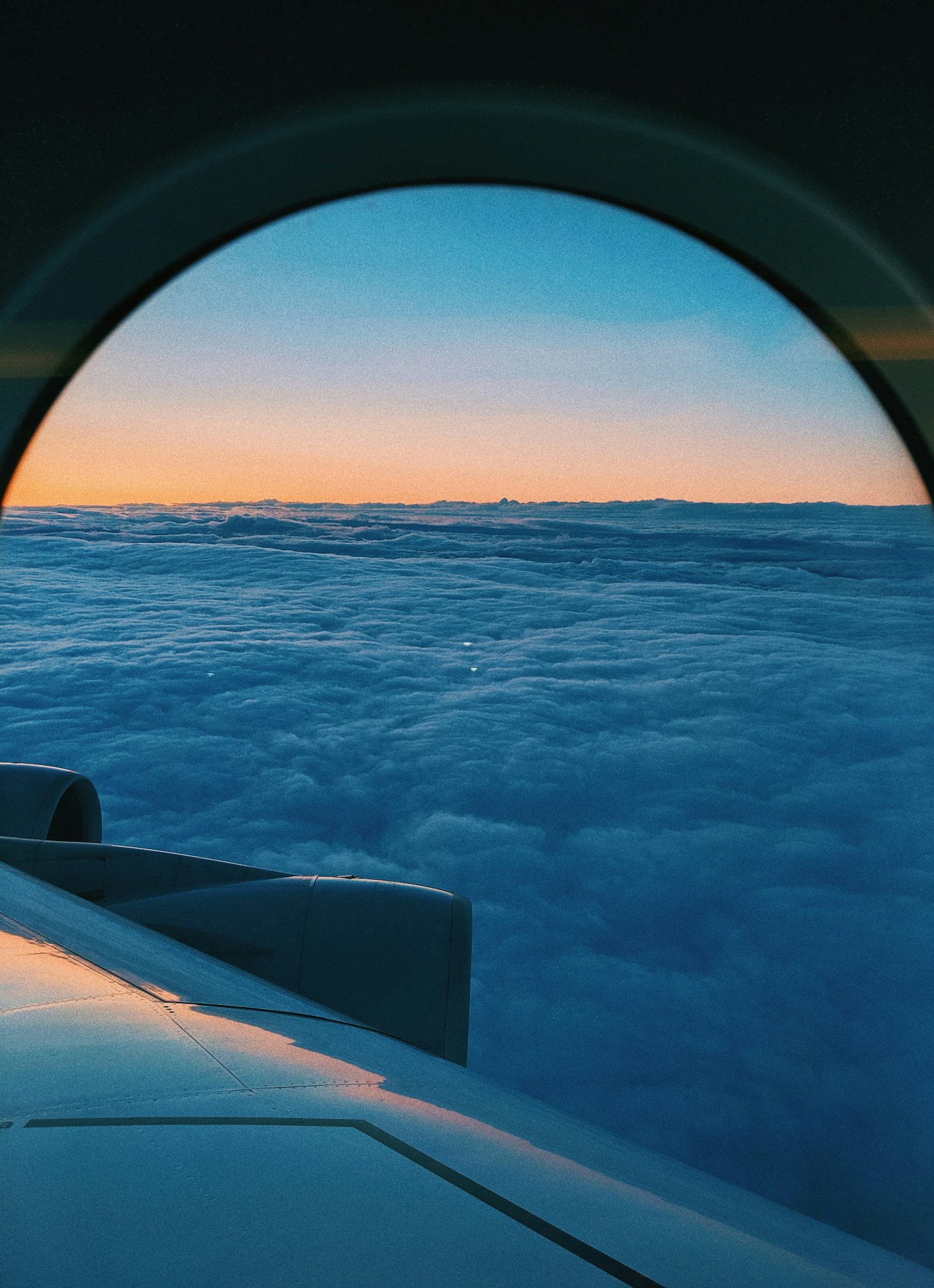 Clouds seen from an aircraft window at dawn