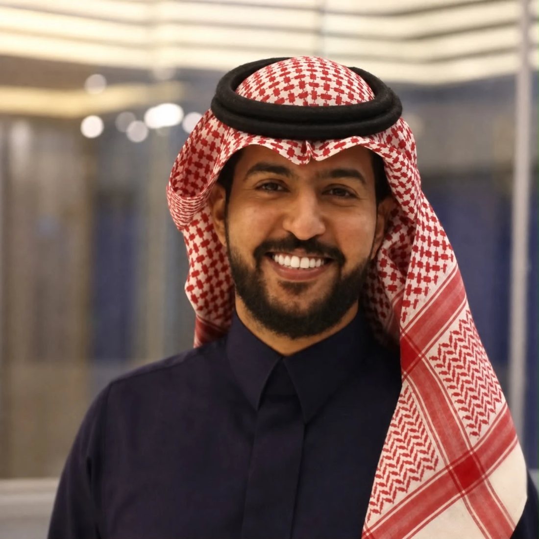 Portrait of Bader Al Sulaiman, Founder and CEO of Mada Trips, wearing a red shemagh